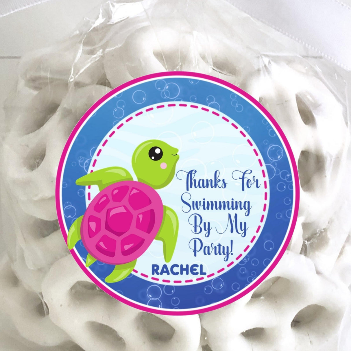 Pink and green sea turtle birthday sticker with ocean background