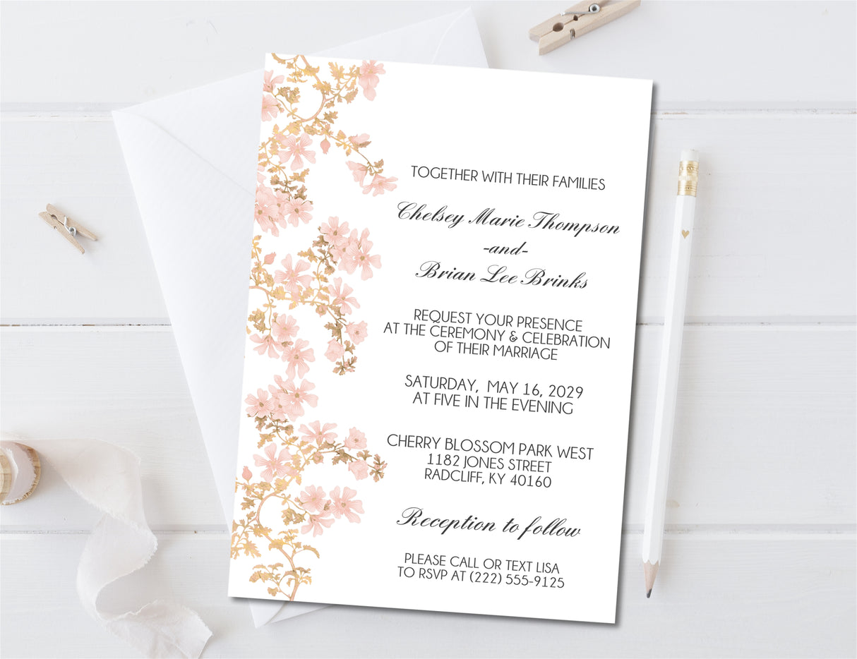 Romantic spring wedding invitation with blush cherry blossoms and coordinating stationery.
