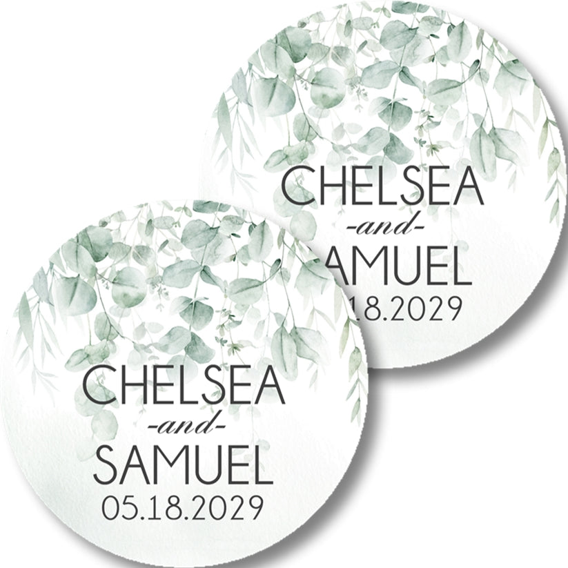 Round wedding favor labels with a soft green watercolor eucalyptus leaf design.