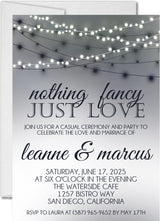 Black and white wedding invitation featuring glowing string lights and elegant typography