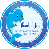 Blue dolphin baby shower sticker with ocean bubbles and wave background