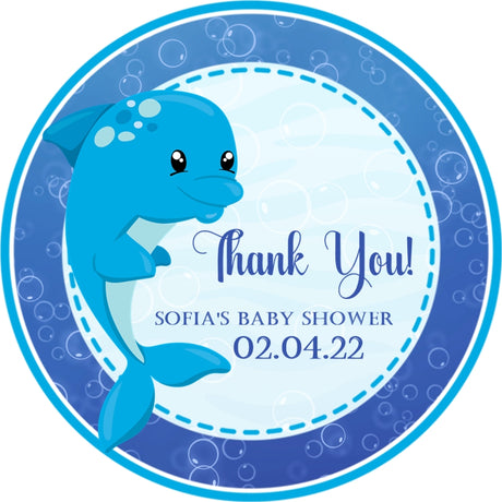 Blue dolphin baby shower sticker with ocean bubbles and wave background