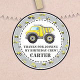 Gray construction birthday sticker with yellow dump truck and personalized name