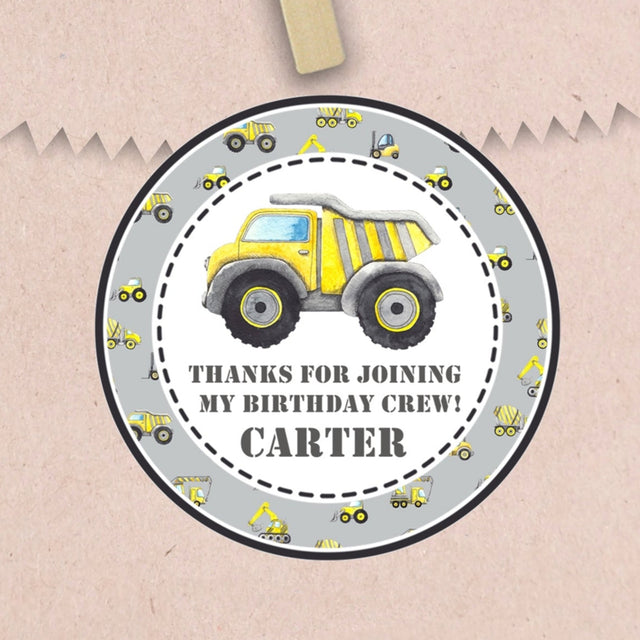 Gray construction birthday sticker with yellow dump truck and personalized name