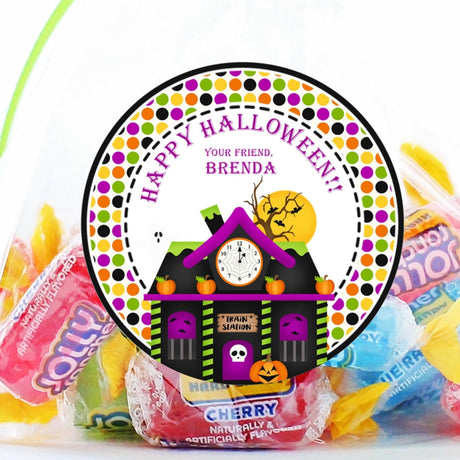 Haunted train station Halloween sticker with pumpkins, bats, and clock tower