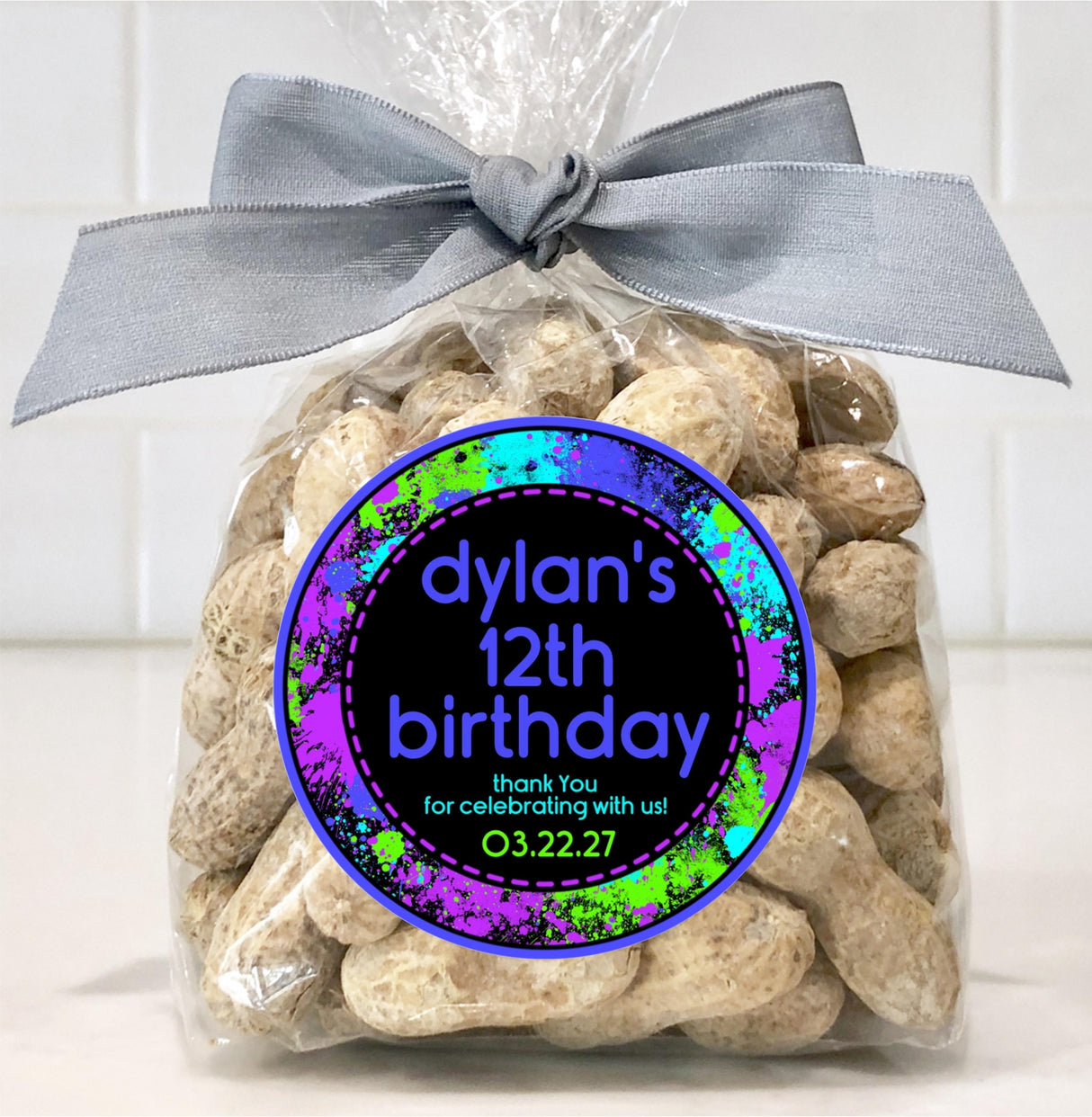 Personalized paintball sticker with blue neon splashes on black background