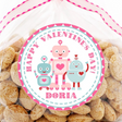 Pink robot Valentine sticker with three robots and heart accents