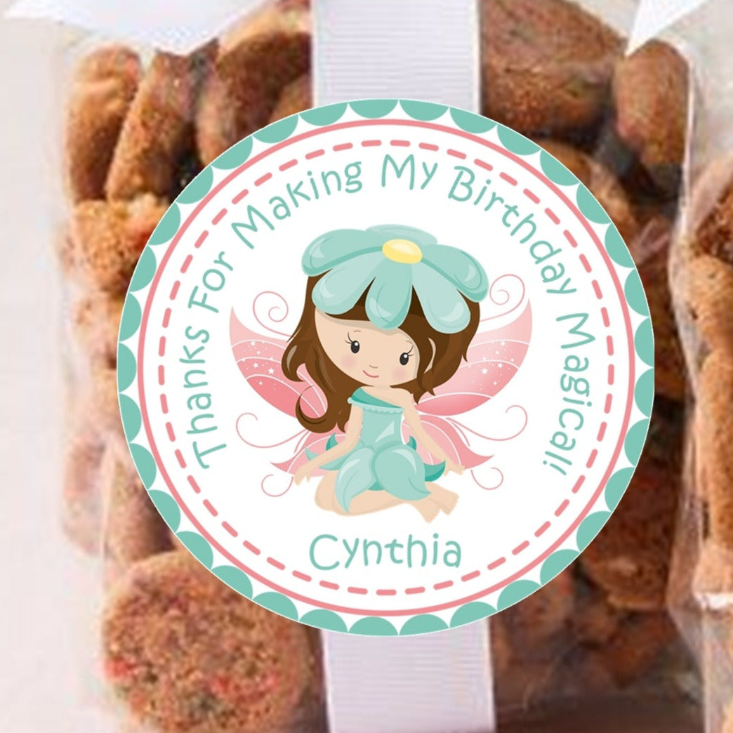 Teal flower fairy birthday sticker with pink wings and personalized name.
