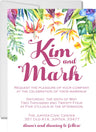 Tropical wedding invitation featuring colorful island flowers and lush botanical greenery
