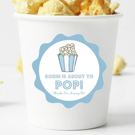 blue popcorn baby shower sticker with “About to Pop” design