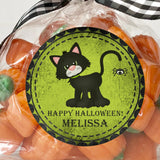 vintage halloween sticker featuring black cat illustration on green background