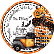 round halloween sticker with vintage truck carrying stacked jack o lanterns